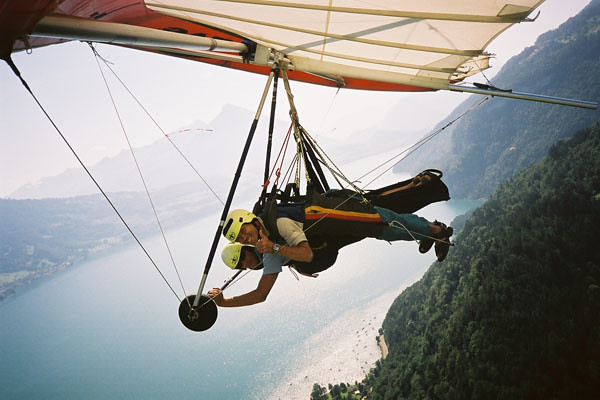 Two people flying a hang glider