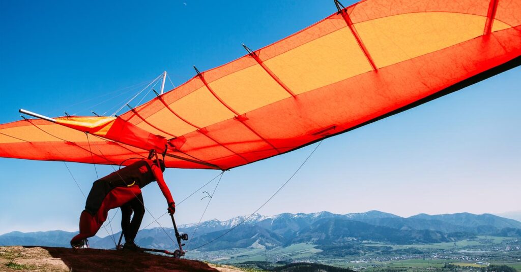 A man is Hang gliding, getting ready to fly