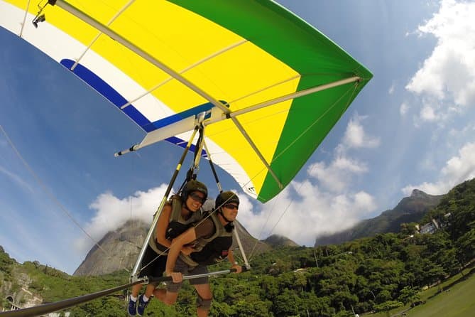 Two people flying on a hang glider