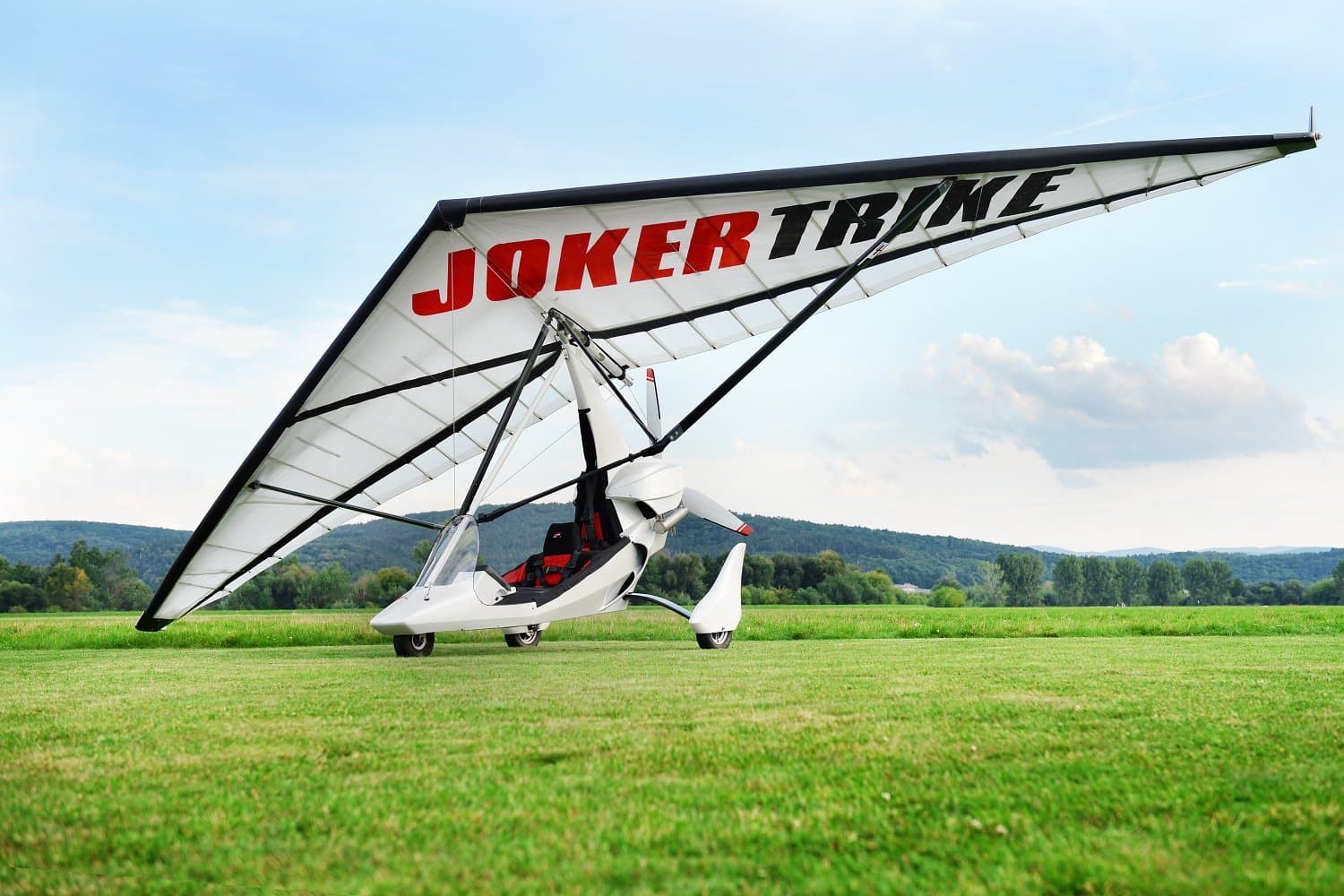 White hang glider standing in a field